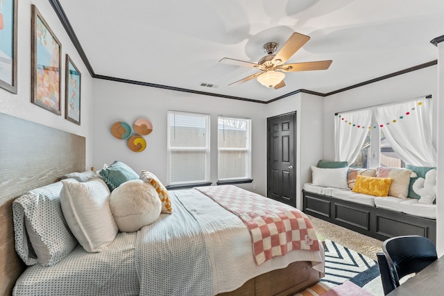 bedroom featuring multiple windows, crown molding, and a ceiling fan