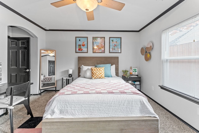 bedroom featuring carpet, ornamental molding, arched walkways, baseboards, and ceiling fan