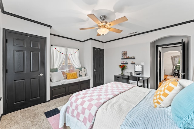 carpeted bedroom featuring arched walkways, ornamental molding, and ceiling fan