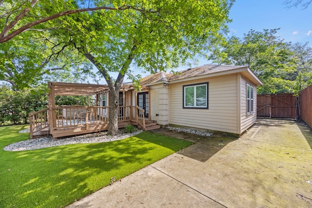 rear view of property with a deck, french doors, a pergola, and a gate