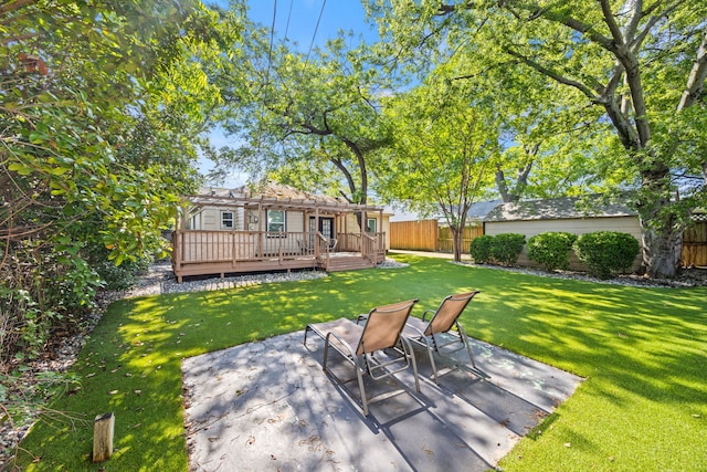 view of yard with a wooden deck and a patio