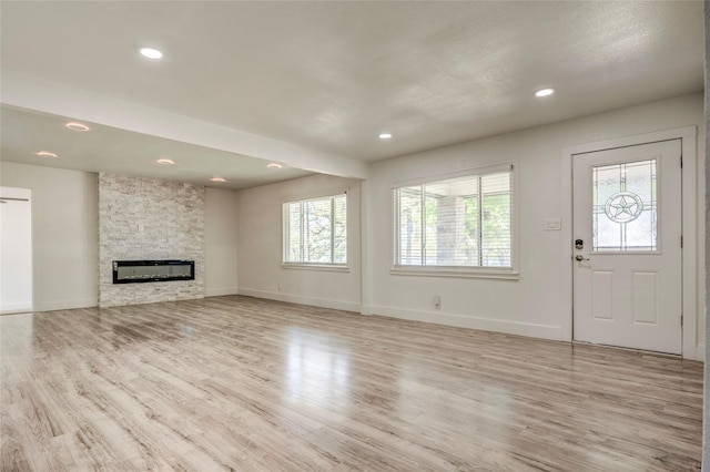 110 Pine St, Weatherford, TX 76086 - unfurnished living room with baseboards, recessed lighting, light wood-style floors, and a fireplace