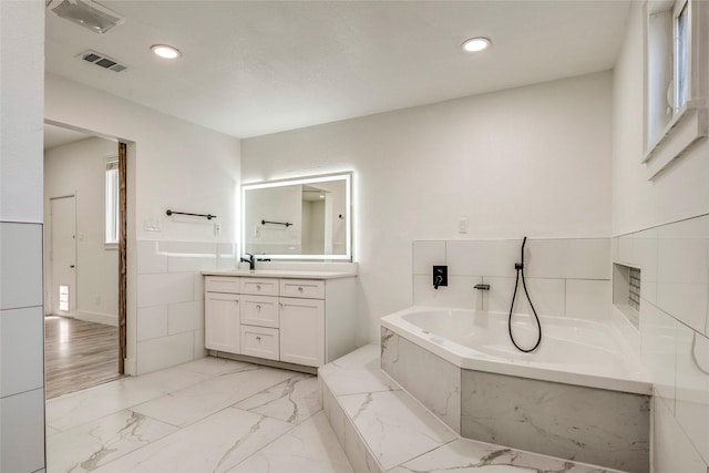 110 Pine St, Weatherford, TX 76086 - bathroom with visible vents, a bath, recessed lighting, vanity, and marble finish floor