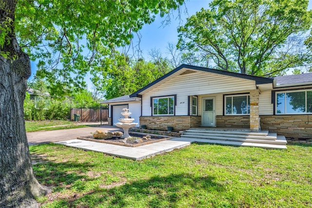 110 Pine St, Weatherford, TX 76086 - exterior space featuring fence, stone siding, a garage, and driveway