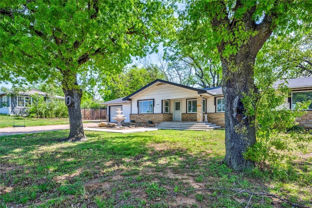 110 Pine St, Weatherford, TX 76086 - single story home featuring driveway, stone siding, a front lawn, an attached garage, and fence