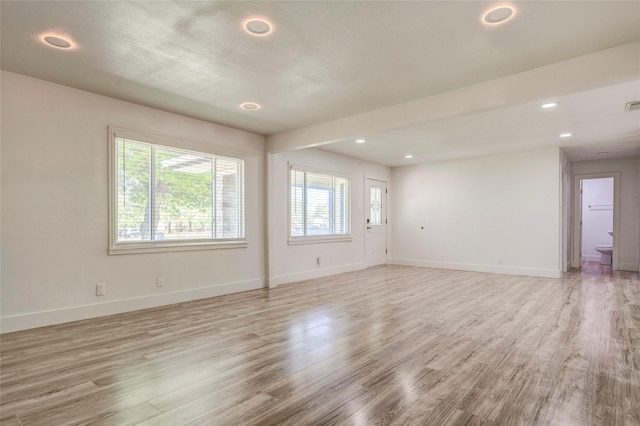 110 Pine St, Weatherford, TX 76086 - unfurnished living room featuring visible vents, baseboards, light wood-type flooring, and recessed lighting