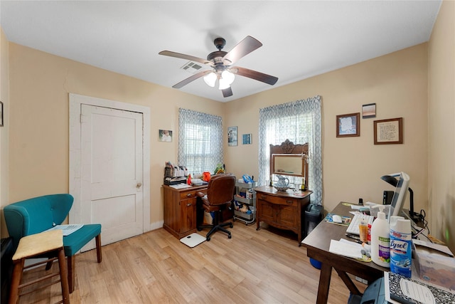 home office with visible vents, light wood-style flooring, and ceiling fan