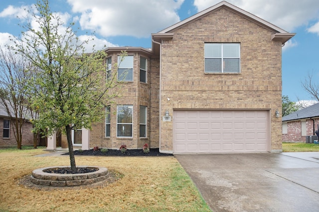 208 Wenrick Dr, Roanoke, TX 76262 - view of front facade with concrete driveway, an attached garage, a front lawn, and brick siding