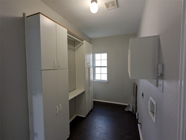 walk in closet featuring dark wood finished floors and visible vents