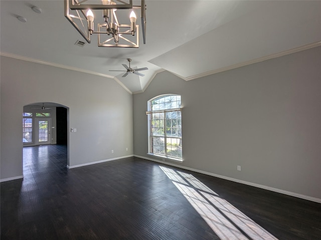 empty room with crown molding, arched walkways, visible vents, and baseboards