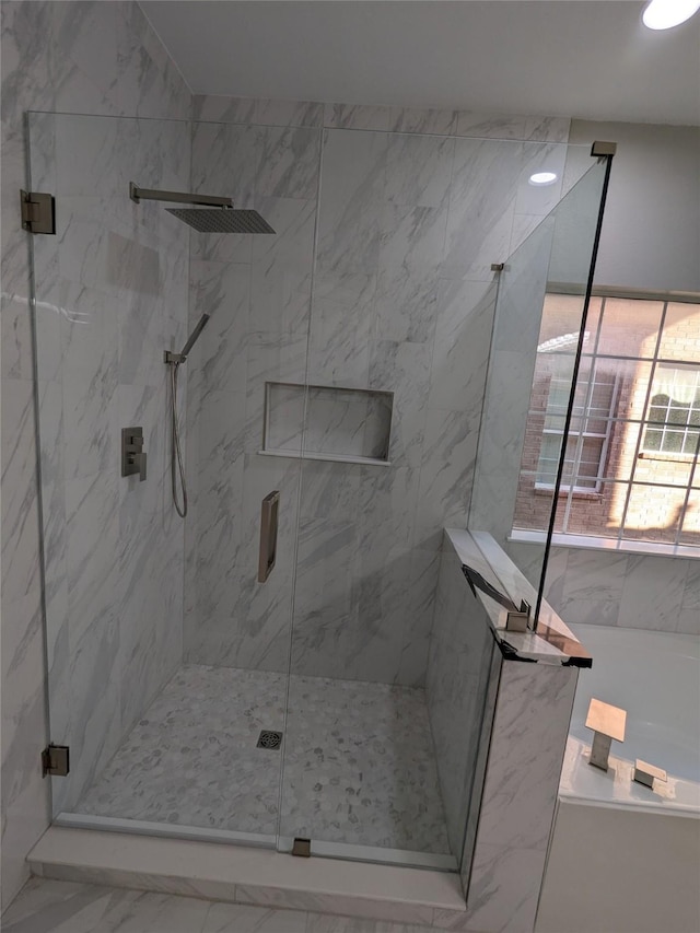 bathroom with a marble finish shower, a bathing tub, and marble finish floor