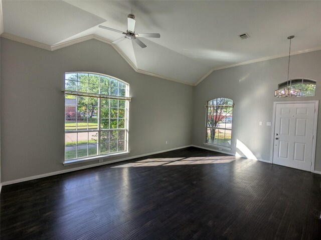 interior space featuring dark wood-style floors, vaulted ceiling, baseboards, ornamental molding, and ceiling fan with notable chandelier