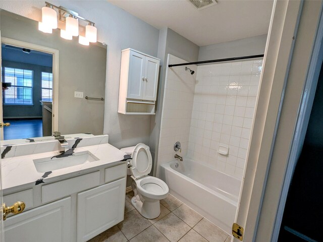 bathroom with visible vents, tub / shower combination, toilet, tile patterned floors, and vanity