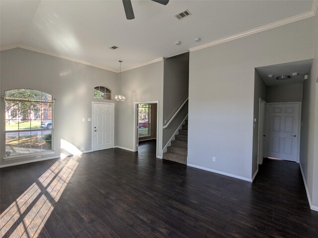 unfurnished living room with stairs, ceiling fan with notable chandelier, baseboards, visible vents, and dark wood-type flooring