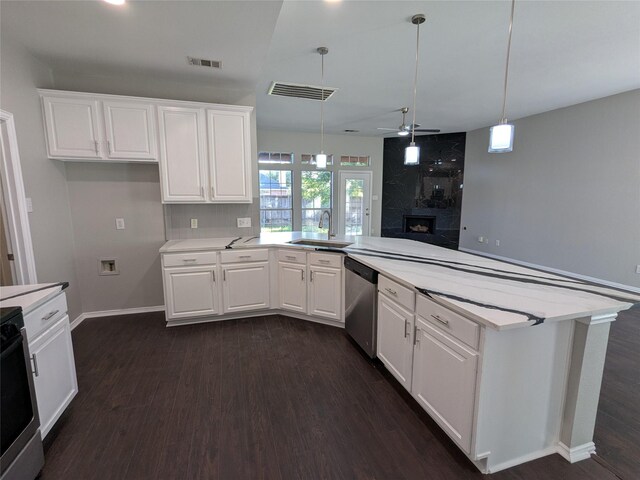 kitchen featuring stainless steel dishwasher, light countertops, dark wood-style floors, a ceiling fan, and a peninsula