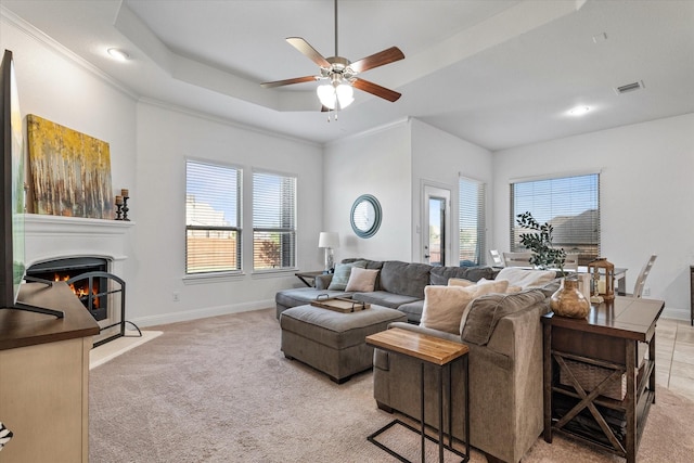 525 Northwood Dr, Oak Point, TX 75068 - living area featuring a warm lit fireplace, a ceiling fan, light colored carpet, baseboards, and crown molding