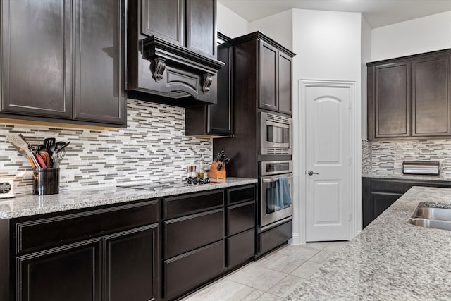 525 Northwood Dr, Oak Point, TX 75068 - kitchen with appliances with stainless steel finishes, backsplash, light stone countertops, and dark brown cabinets
