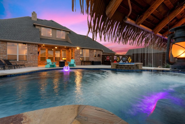 8370 Old Springtown Rd, Springtown, TX 76082 - pool at dusk featuring a patio, an in ground hot tub, a fenced in pool, and fence