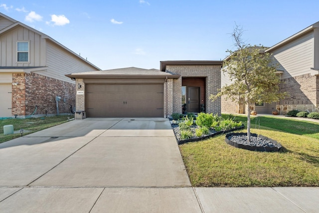 view of front facade featuring brick siding, a front lawn, a garage, and driveway