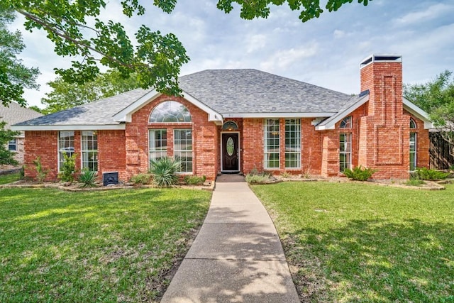 511 Windsor Way, Rockwall, TX 75087 - view of front facade featuring a front yard, a chimney, and roof with shingles