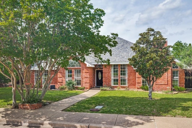 511 Windsor Way, Rockwall, TX 75087 - view of front of home featuring a front yard, brick siding, and roof with shingles