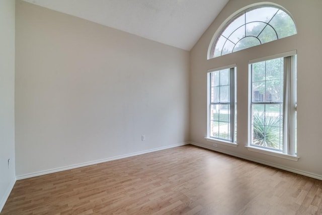 511 Windsor Way, Rockwall, TX 75087 - unfurnished room with healthy amount of natural light, wood finished floors, baseboards, and high vaulted ceiling