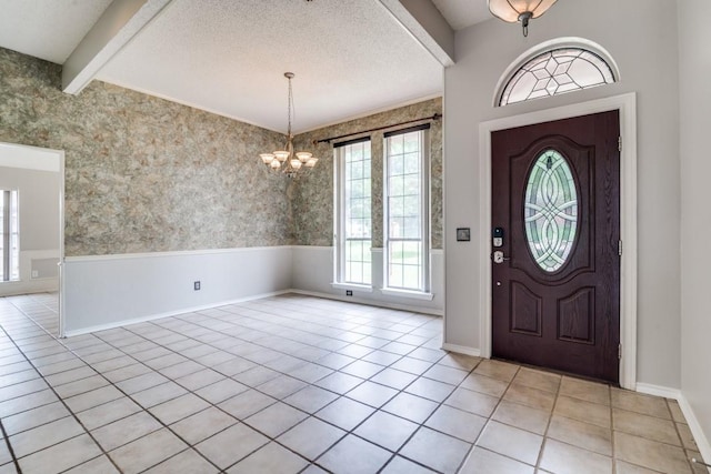 511 Windsor Way, Rockwall, TX 75087 - entryway featuring baseboards, a chandelier, beam ceiling, a wainscoted wall, and light tile patterned floors