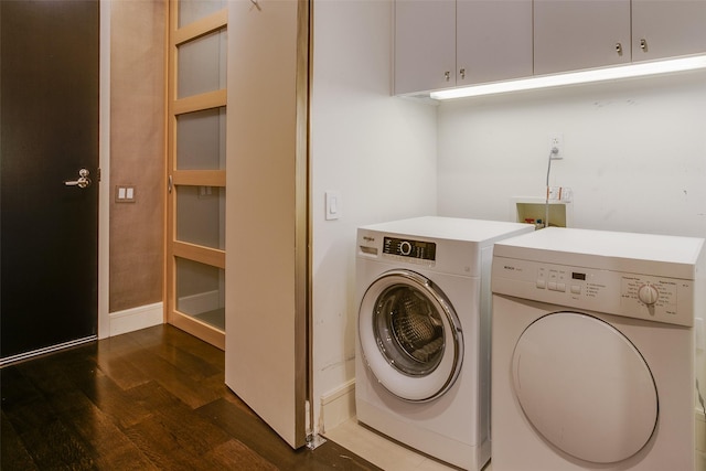 2408 Victory Park Ln Unit 1031, Dallas, TX 75219 - washroom with separate washer and dryer, wood finished floors, baseboards, and cabinet space