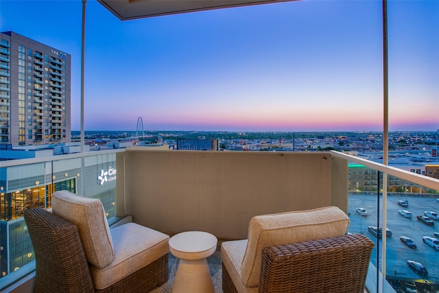 2408 Victory Park Ln Unit 1031, Dallas, TX 75219 - balcony at dusk featuring a view of city