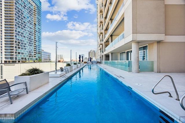 2408 Victory Park Ln Unit 1031, Dallas, TX 75219 - community pool featuring a patio and a view of city