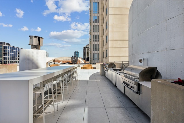 2408 Victory Park Ln Unit 1031, Dallas, TX 75219 - view of patio / terrace with area for grilling, outdoor wet bar, a view of city, and a grill