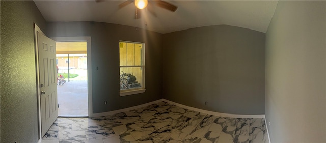 foyer featuring marble finish floor, ceiling fan, baseboards, and vaulted ceiling