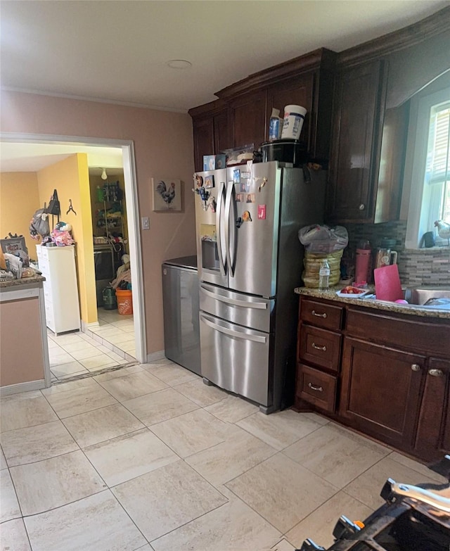 kitchen featuring tasteful backsplash, light tile patterned floors, dark brown cabinets, and stainless steel refrigerator with ice dispenser