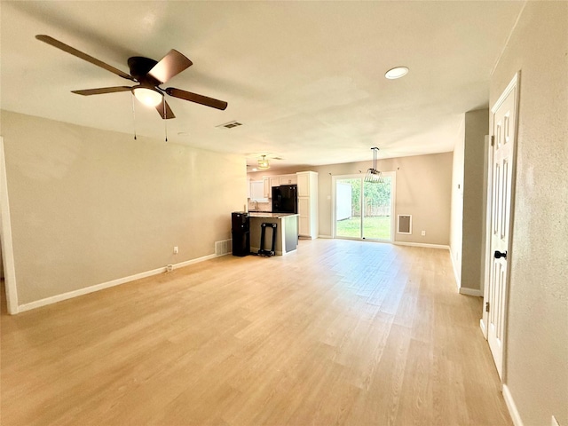 1901 SE 12th St, Mineral Wells, TX 76067 - unfurnished living room with ceiling fan, light wood-type flooring, and baseboards