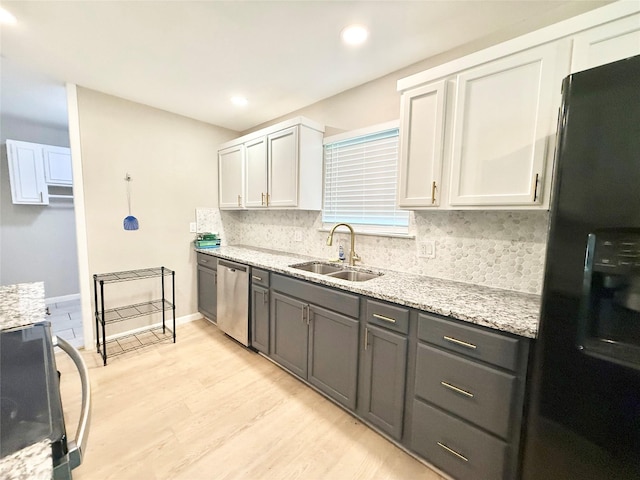 1901 SE 12th St, Mineral Wells, TX 76067 - kitchen with freestanding refrigerator, dishwasher, range, light wood-type flooring, and decorative backsplash
