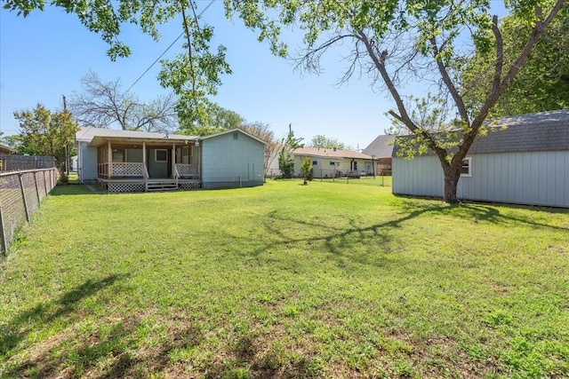 view of yard featuring a fenced backyard and an outbuilding