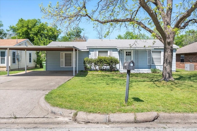 ranch-style home featuring a carport, driveway, and a front lawn