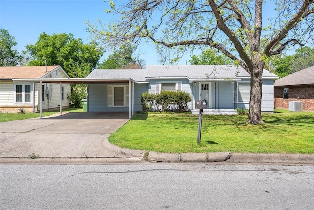 ranch-style home with a carport, concrete driveway, and a front lawn