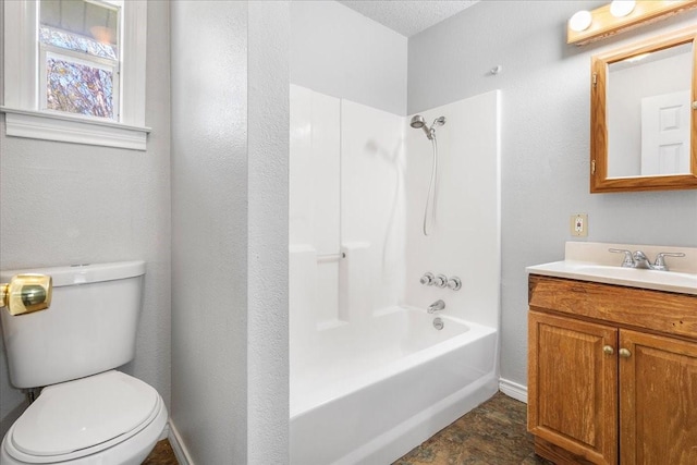 bathroom featuring vanity, bathtub / shower combination, and toilet