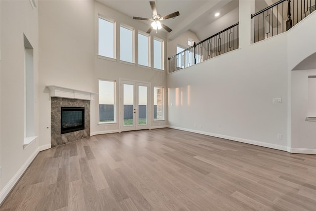6926 Prairieside Trl, Prairie Ridge, TX 76084 - unfurnished living room with ceiling fan, a high ceiling, wood finished floors, and baseboards