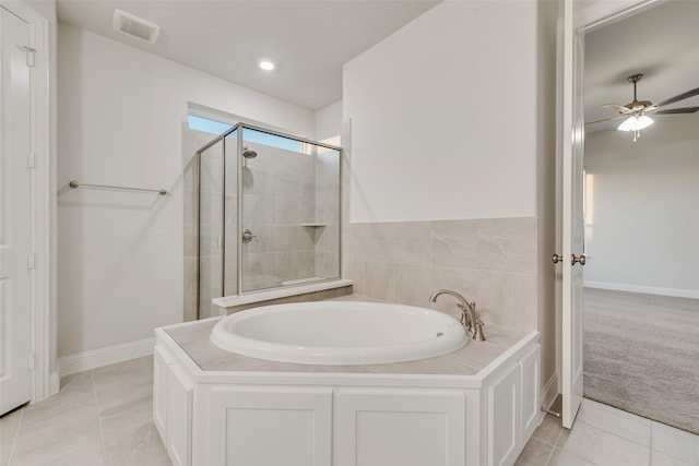 6926 Prairieside Trl, Prairie Ridge, TX 76084 - bathroom with a shower stall, a bath, a ceiling fan, and baseboards