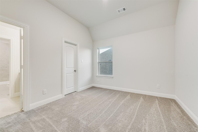 6926 Prairieside Trl, Prairie Ridge, TX 76084 - unfurnished bedroom with carpet flooring, vaulted ceiling, baseboards, and connected bathroom