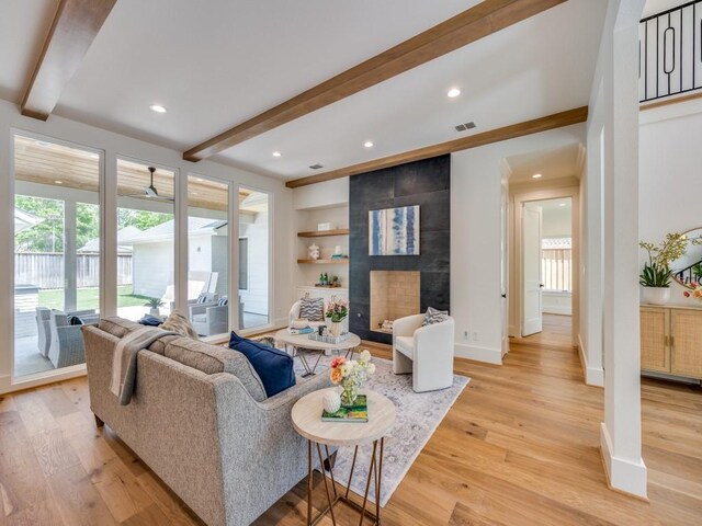 6909 Middle Cove Dr, Dallas, TX 75248 - living area featuring visible vents, beam ceiling, light wood-style flooring, and baseboards