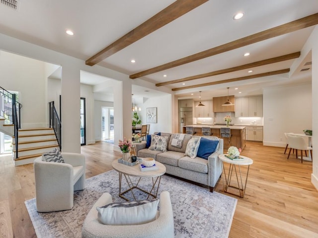 6909 Middle Cove Dr, Dallas, TX 75248 - living area with visible vents, beamed ceiling, plenty of natural light, and stairway