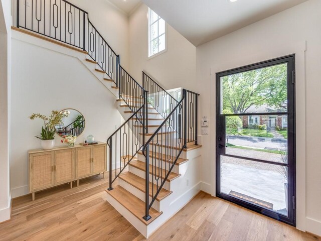 6909 Middle Cove Dr, Dallas, TX 75248 - entrance foyer featuring baseboards, light wood-type flooring, a towering ceiling, and stairway