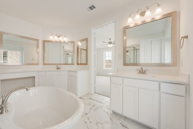 bathroom featuring marble look tile flooring, a stall shower, a soaking tub, and two vanities