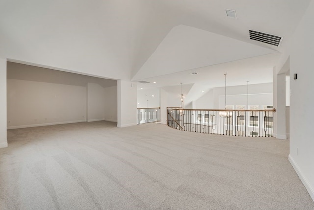 empty room with high vaulted ceiling, carpet floors, and baseboards