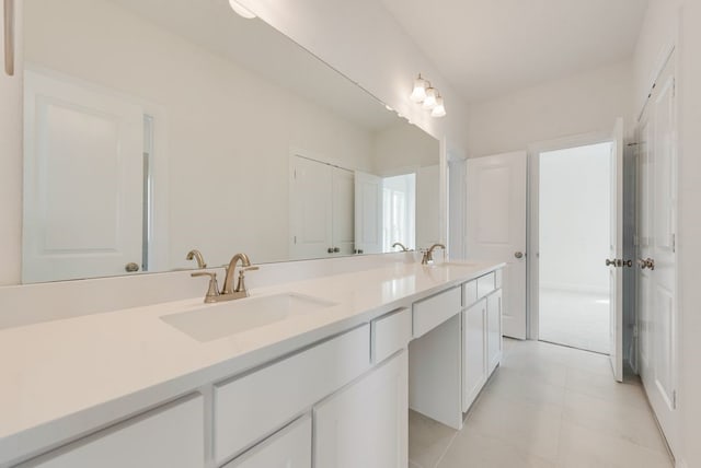 full bath with double vanity and tile patterned flooring
