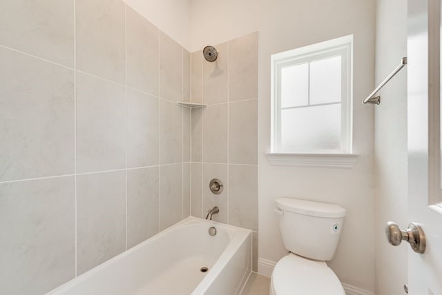 bathroom with toilet, washtub / shower combination, and baseboards