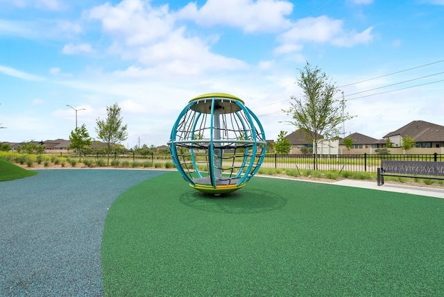 view of play area with fence and a residential view